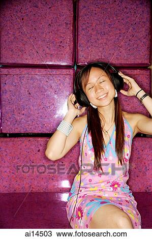 Young woman, wearing headphones, eyes closed View Large Photo Image Stock Image - Young woman, wearing headphones, eyes closed. Fotosearch