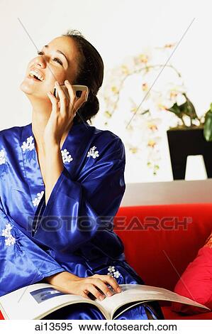 Young woman wearing robe, using mobile phone View Large Photo Image Stock Photography - Young woman wearing robe, using mobile phone. Fotosearch