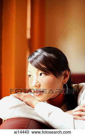 Young woman with arms crossed, head on arms, looking away View Large Photo Image Stock Image - Young woman with arms crossed, head on arms, looking away. Fotosearch