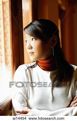 Young woman with arms crossed, looking out of window View Large Photo Image Picture - Young woman with arms crossed, looking out of window. Fotosearch