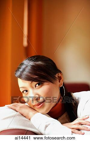Young woman with arms crossed, looking at camera View Large Photo Image Stock Image - Young woman with arms crossed, looking at camera. Fotosearch