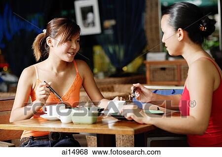 Young women at cafe, having coffee View Large Photo Image Stock Photo - Young women at cafe, having coffee. Fotosearch