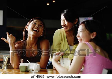 Stock Photography - Young women at cafe. Fotosearch