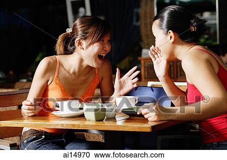 Young women at cafe, talking over coffee View Large Photo Image Stock Image - Young women at cafe, talking over coffee. Fotosearch