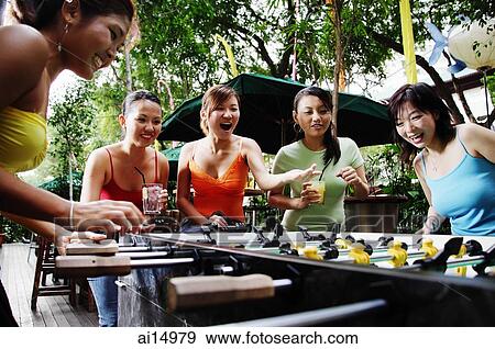 Young women playing foosball, low angle view View Large Photo Image Stock Photo - Young women playing foosball, low angle view. Fotosearch