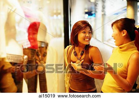 Stock Photo - Young women window shopping. Fotosearch