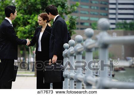 Business people shaking hands, buildings in the background View Large Photo Image Stock Image - Business people shaking hands, buildings in the background . Fotosearch