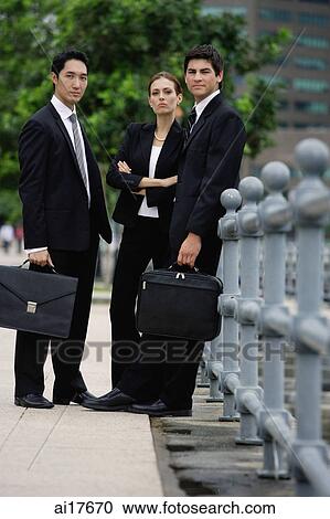 Business people standing, looking at camera View Large Photo Image Stock Image - Business people standing, looking at camera . Fotosearch