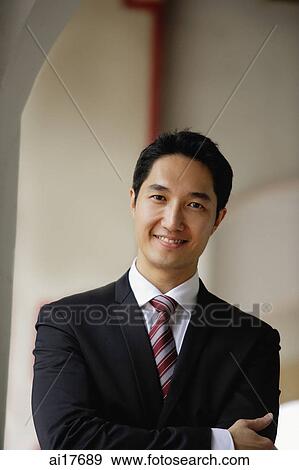 Businessman looking at camera, smiling, portrait View Large Photo Image Stock Photo - Businessman looking at camera, smiling, portrait . Fotosearch