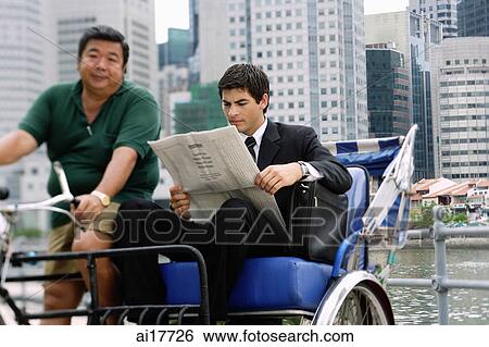 Businessman sitting in trishaw, reading newspaper View Large Photo Image Stock Photograph - Businessman sitting in trishaw, reading newspaper. Fotosearch
