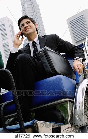 Businessman sitting in trishaw, using mobile phone View Large Photo Image Stock Photography - Businessman sitting in trishaw, using mobile phone . Fotosearch
