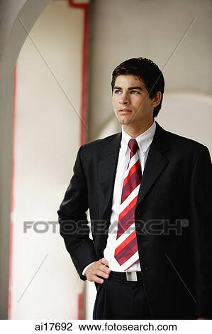 Businessman standing with hand on hip View Large Photo Image Stock Image - Businessman standing with hand on hip . Fotosearch
