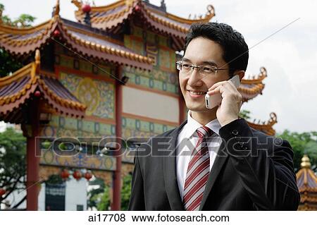 Stock Photo - Businessman using mobile phone . Fotosearch