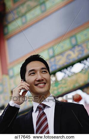 Businessman using mobile phone View Large Photo Image Stock Photography - Businessman using mobile phone . Fotosearch
