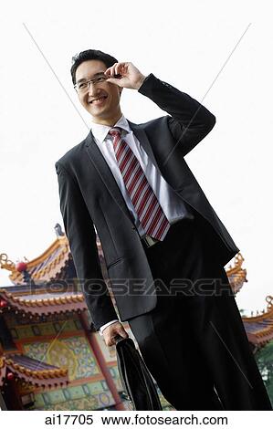 Businessman with briefcase, smiling View Large Photo Image Stock Photography - Businessman with briefcase, smiling. Fotosearch