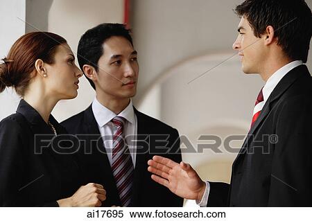 Stock Photography - Businessmen and businesswoman having a discussion . Fotosearch
