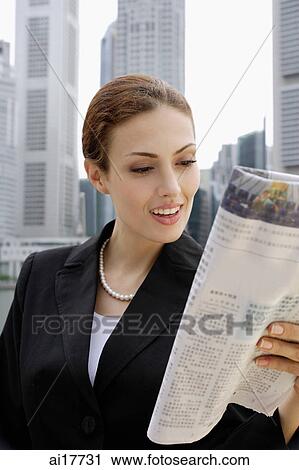 Businesswoman reading newspaper View Large Photo Image Stock Image - Businesswoman reading newspaper. Fotosearch