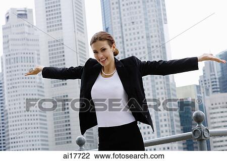 Businesswoman with arms outstretched, looking at camera, smiling View Large Photo Image Stock Image - Businesswoman with arms outstretched, looking at camera, smiling . Fotosearch