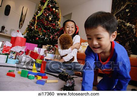 Children opening gifts on Christmas View Large Photo Image Stock Image - Children opening gifts on Christmas . Fotosearch