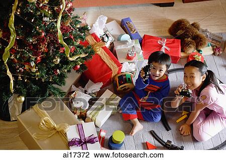 Children with opened Christmas presents, showing toys to camera View Large Photo Image Stock Image - Children with opened Christmas presents, showing toys to camera . Fotosearch