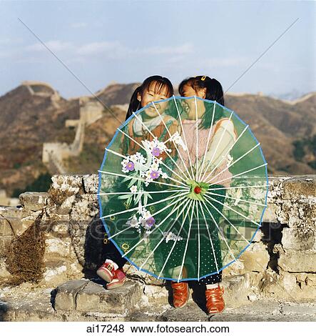China, near Beijing, The Great Wall, Jinshanling, local children sitting on wall, holding parasol View Large Photo Image Stock Photo - China, near Beijing, The Great Wall, Jinshanling, local children sitting on wall, holding parasol . Fotosearch