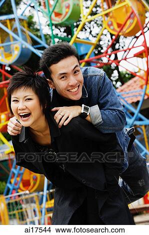 Couple at playground, looking at camera, smiling View Large Photo Image Picture - Couple at playground, looking at camera, smiling . Fotosearch