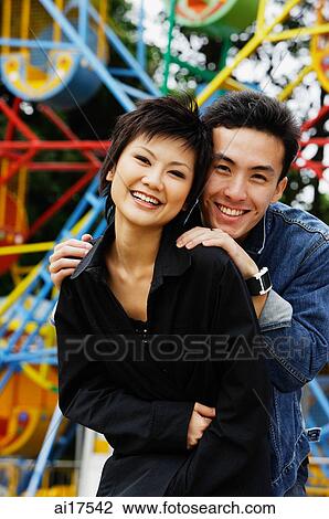 Couple at playground, smiling at camera View Large Photo Image Stock Image - Couple at playground, smiling at camera . Fotosearch