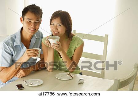 Stock Photograph - Couple drinking at cafe . Fotosearch