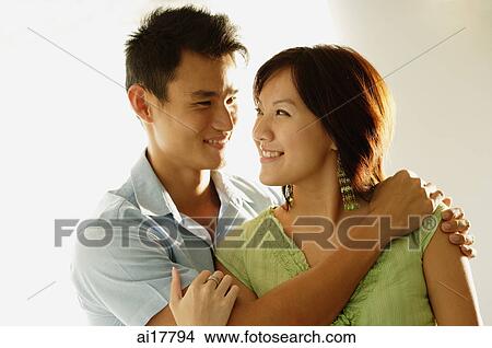 Couple embracing, looking at each other View Large Photo Image Picture - Couple embracing, looking at each other. Fotosearch