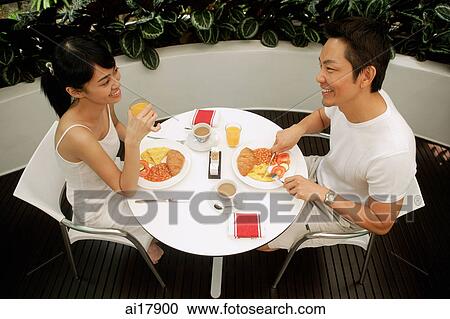 Couple having breakfast on patio View Large Photo Image Stock Image - Couple having breakfast on patio . Fotosearch
