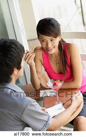 Couple having dessert at a cafe View Large Photo Image Stock Image - Couple having dessert at a cafe. Fotosearch