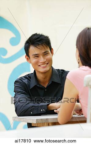 Couple sitting opposite from each other View Large Photo Image Stock Image - Couple sitting opposite from each other. Fotosearch