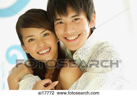 Stock Image - Couple smiling at camera . Fotosearch