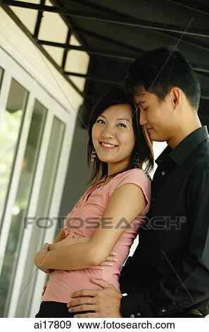 Couple standing together, side view View Large Photo Image Stock Photo - Couple standing together, side view . Fotosearch