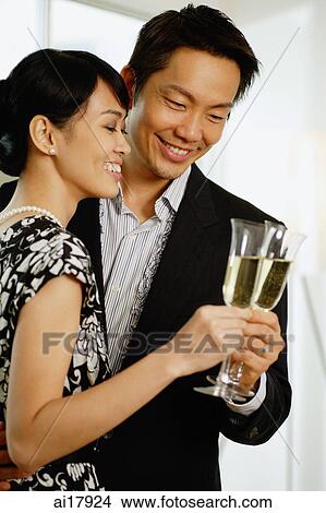 Couple toasting with champagne glasses View Large Photo Image Picture - Couple toasting with champagne glasses. Fotosearch