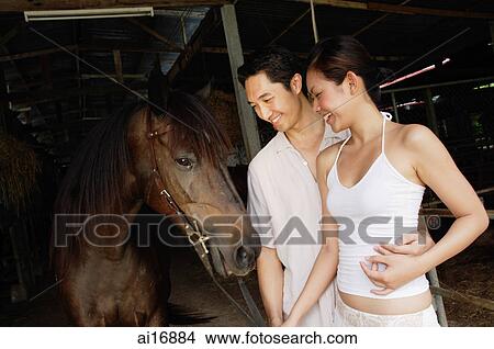 Couple with horse in stable View Large Photo Image Picture - Couple with horse in stable . Fotosearch