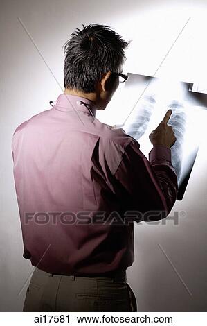 Doctor holding X-ray, rear view View Large Photo Image Stock Image - Doctor holding X-ray, rear view . Fotosearch