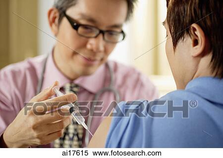 Doctor injecting patient View Large Photo Image Stock Photography - Doctor injecting patient . Fotosearch