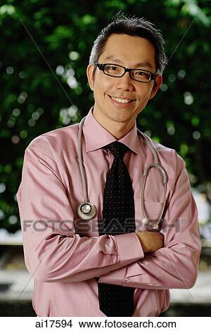 Doctor wearing stethoscope around his neck, arms crossed View Large Photo Image Picture - Doctor wearing stethoscope around his neck, arms crossed. Fotosearch
