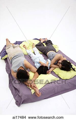 Family with one child, sleeping on bed View Large Photo Image Picture - Family with one child, sleeping on bed . Fotosearch