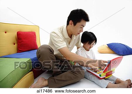 Father and daughter looking at childrens laptop View Large Photo Image Stock Photograph - Father and daughter looking at childrens laptop . Fotosearch