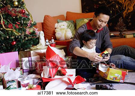 Father and son opening gifts on Christmas, portrait View Large Photo Image Stock Image - Father and son opening gifts on Christmas, portrait . Fotosearch