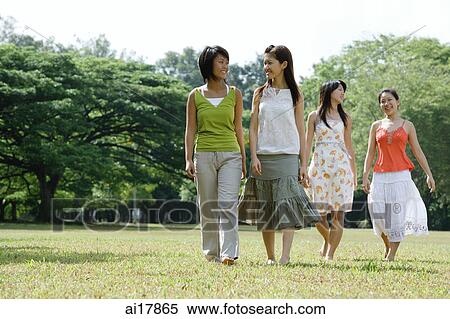 Four young women walking across field View Large Photo Image Stock Photography - Four young women walking across field. Fotosearch