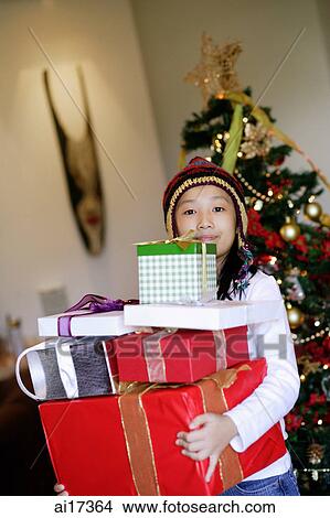 Picture - Girl carrying wrapped gift boxes . Fotosearch