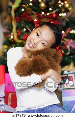 Girl holding teddy bear, looking at camera View Large Photo Image Stock Image - Girl holding teddy bear, looking at camera . Fotosearch