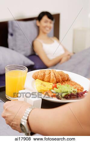 Man carrying breakfast tray View Large Photo Image Stock Photo - Man carrying breakfast tray . Fotosearch