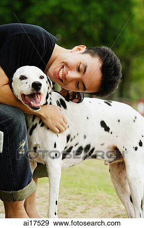 Man embracing dog View Large Photo Image Stock Photo - Man embracing dog . Fotosearch