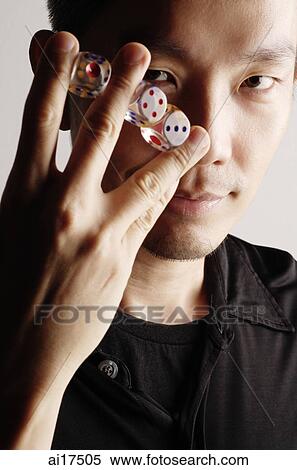 Man holding three dice between fingers View Large Photo Image Stock Photography - Man holding three dice between fingers . Fotosearch
