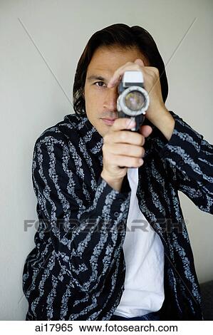 Man holding video camera View Large Photo Image Stock Photography - Man holding video camera. Fotosearch