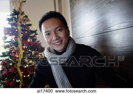 Man in sweater and scarf, smiling at camera View Large Photo Image Stock Image - Man in sweater and scarf, smiling at camera . Fotosearch